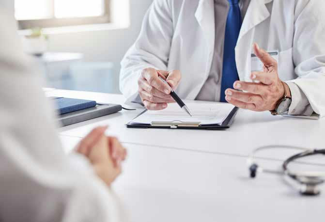 A doctor explaining a form across a desk