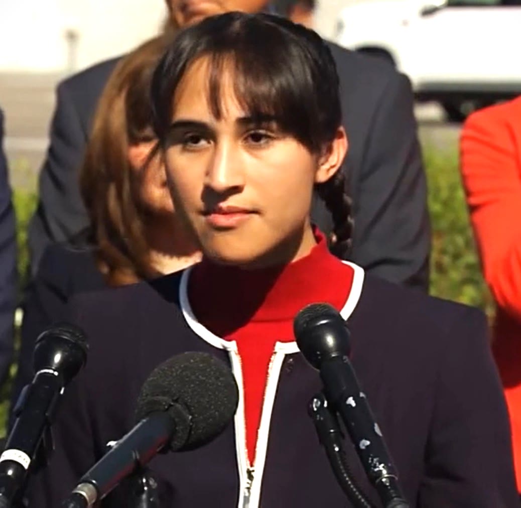 Chloe Cole at a microphone