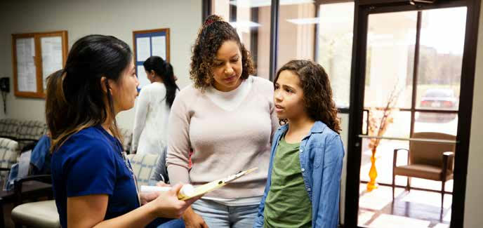 A mother and daughter at a clinic reception desk